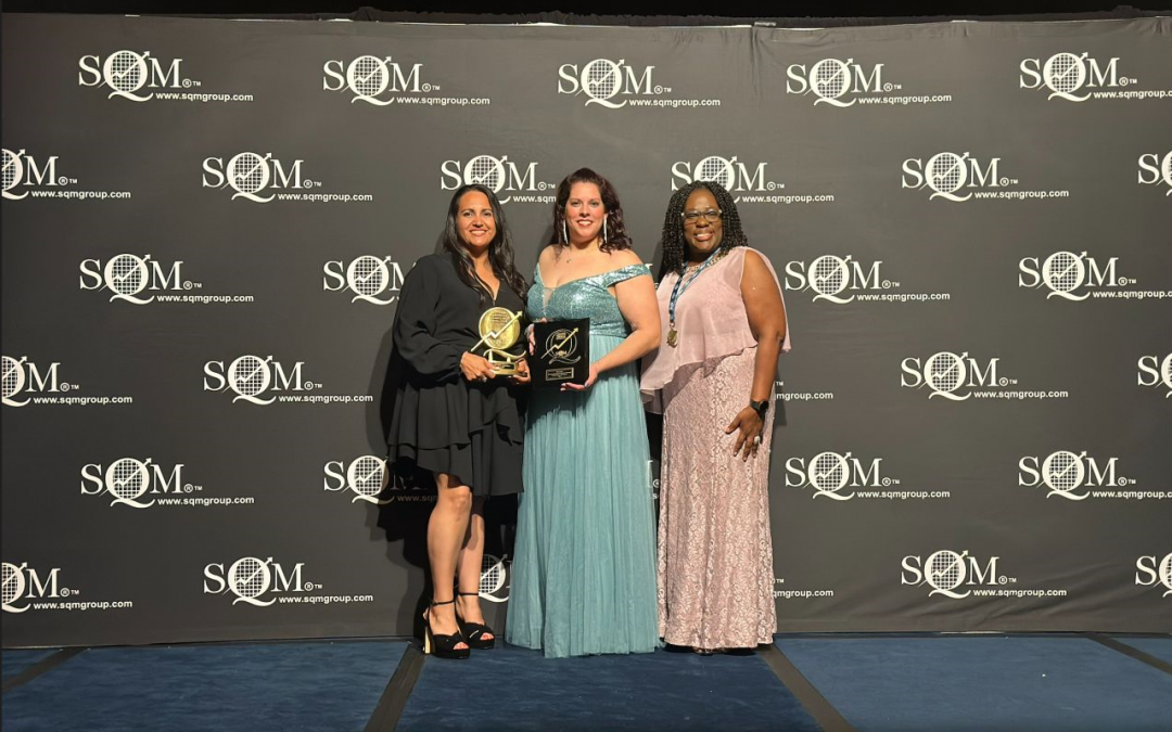 Mr. Cooper team members Elisa Rios, Jessica Forsman and Chandra Hawley are recognized on stage at the SQM Industry Award ceremony.